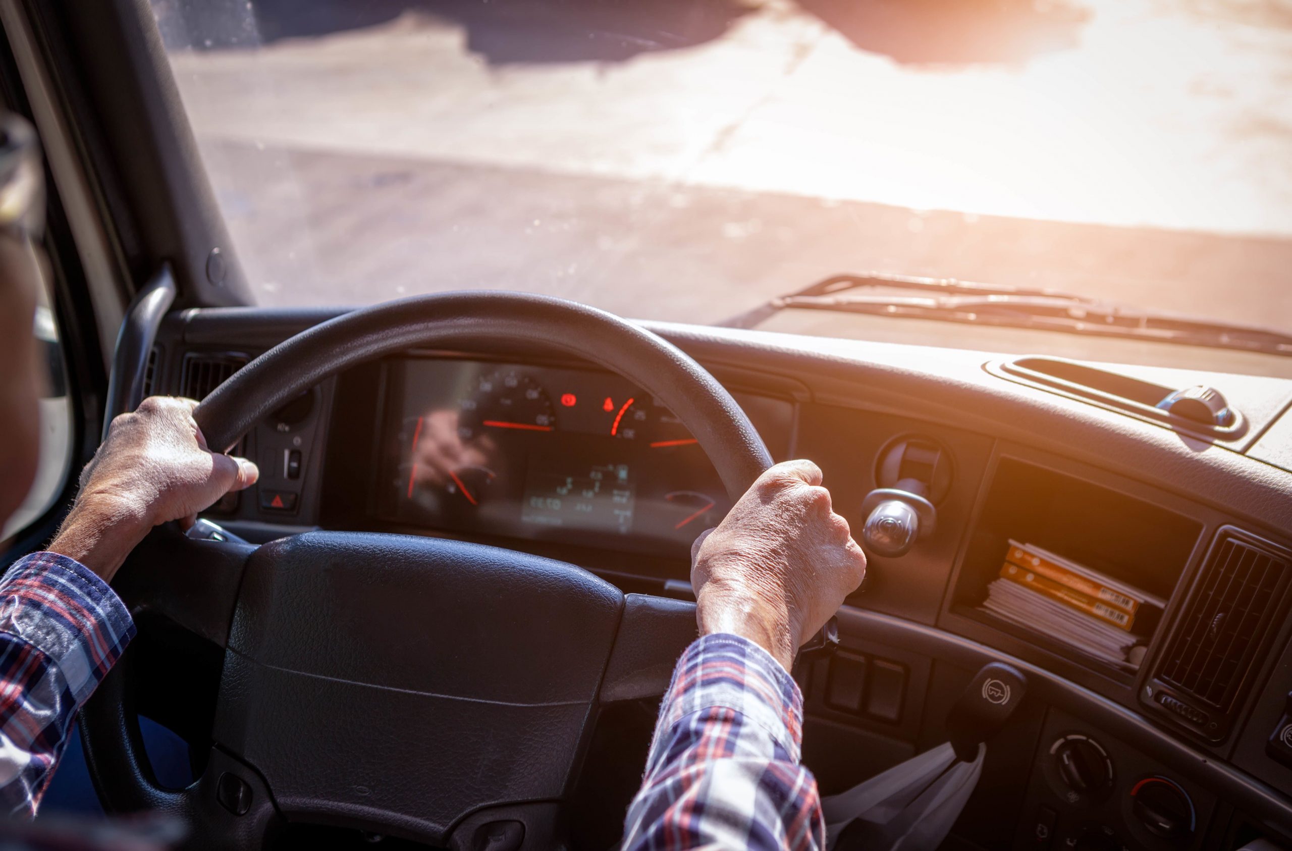 Truck driver with hands on the steering wheel