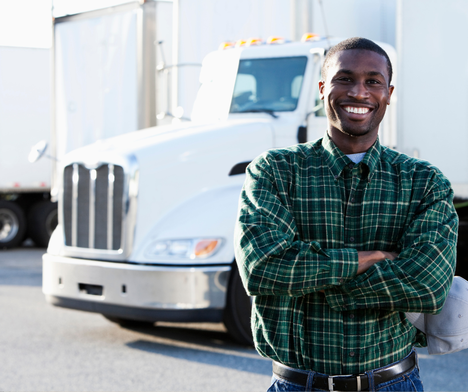 Man smiling next to tractor trailer