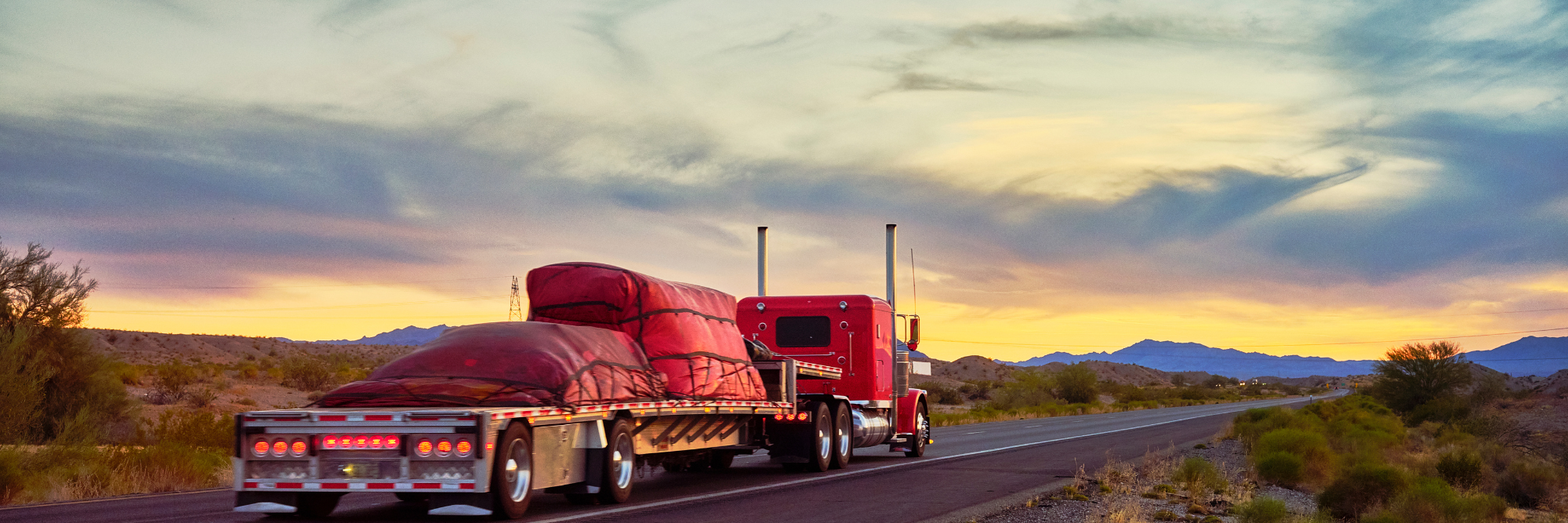 tractor trailer transporting cargo across desert